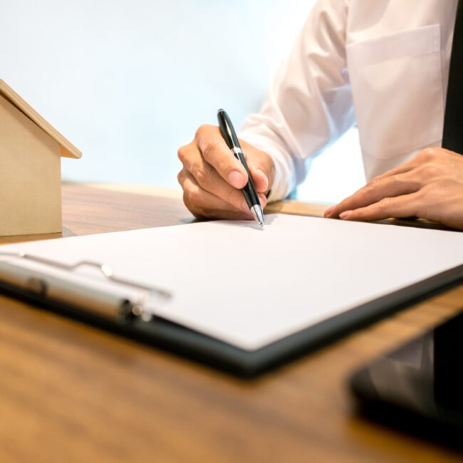 Real Estate agent with contract signature and analyzing valuation of house property